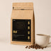 Guji Natural Reserve – bag next to a cup of coffee