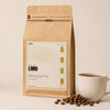Limu – bag next to a cup of coffee